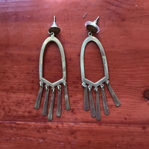 Brass earrings handmade by artisans in Peru.